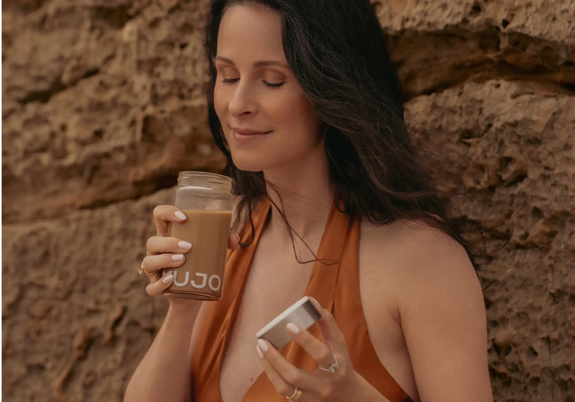 Mujo founder drinking mujo coffee alternative on the beach