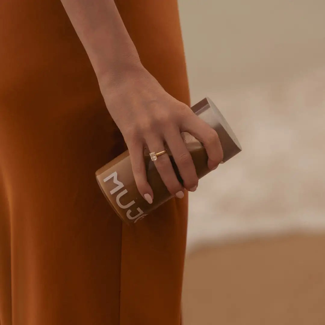 Brown muji travel mug with matte finish and minimalist white lettering.